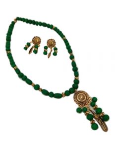 Necklace with green beads and golden pendant 